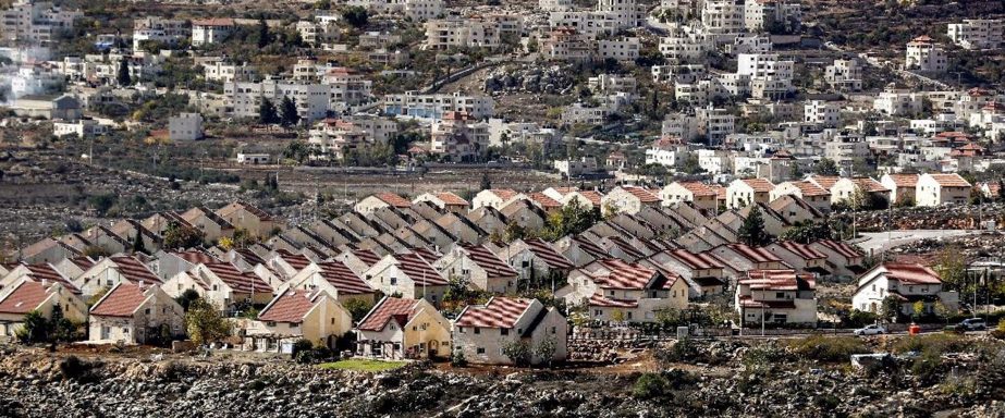 Houses are seen in the settlement of Ofra in the Israeli-occupied West Bank, established in the vicinity of the Palestinian village of Baytin (background).