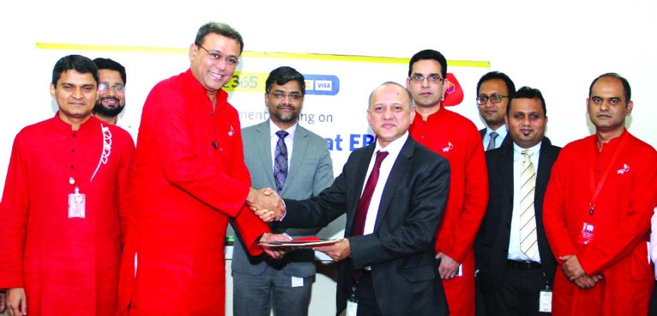 Ahmed Shaheen, Deputy Managing Director of Eastern Bank Ltd (EBL) and Pradeep Shrivastava, Chief Commercial Officer of Robi Axiata Limited exchanging documents after signing a deal in the city recently. Under the deal EBL card holders will be able to top-