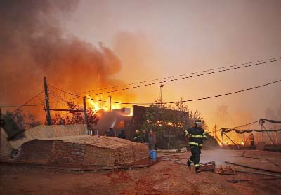 Firefighters helps extinguish a new fire that broke out in the Israeli town of Nataf, west of the Arab Israeli town of Abu Ghosh, along the border with the occupied West Bank