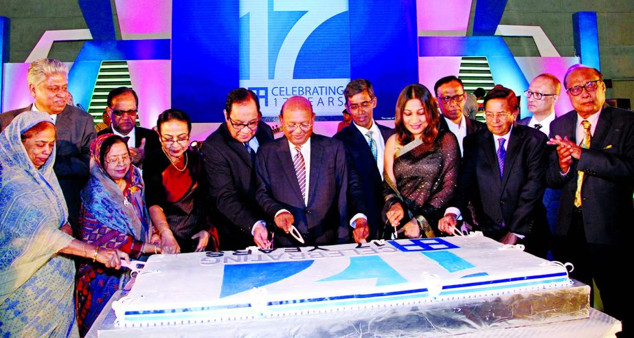 Commerce Minister Tofail Ahmed, Chairman of Bank Asia A Rouf Chowdhury, are seen cutting anniversary celebration cake at a function held in the city recently. Vice Chairmen Md Safwan Choudhury, Directors Hosne Ara Sinha and M Shahajahan Bhuiyan and Manag