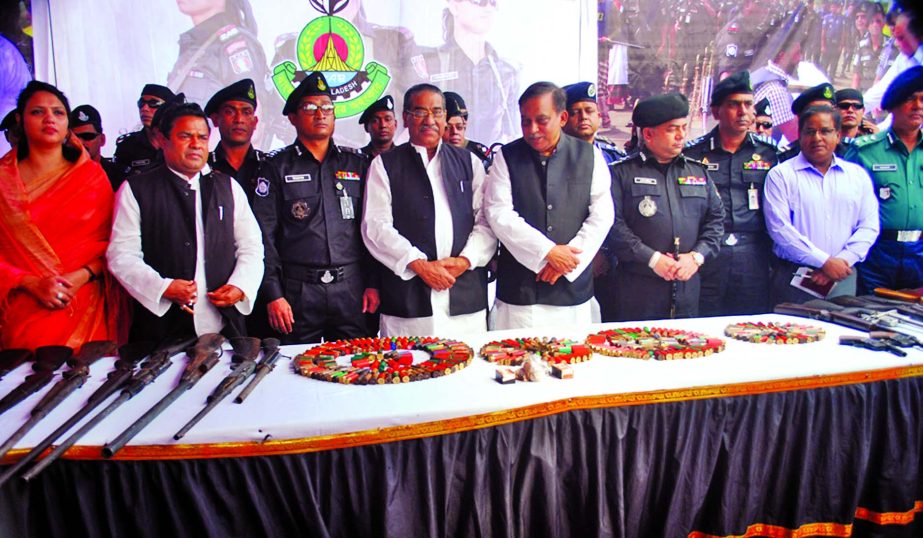 Twelve pirates from Sundarbans, including the ringleader of Khoka Babu Bahini, surrender their arms and ammunition to the Home Minister Asaduzzaman Khan Kamal at Rapid Action Battalion-8 Office at Rupatoli in Barisal city on Monday.
