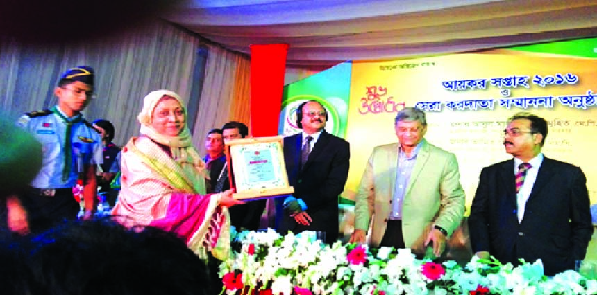 Monwara Begum, executive director of 'Prottyashi' 2nd received tax card for the tax year 2015-2016 recently in the city. The award was handed over by Nazibur Rahman, Chairman of National Board of Revenue (NBR), State Minister for Finance and Planning, M