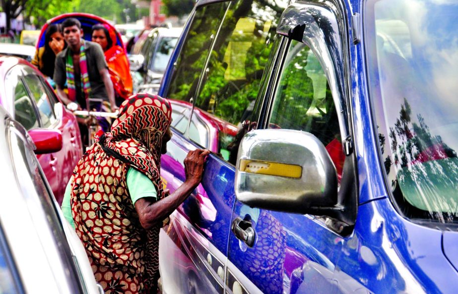 Begging in the city streets on the rise despite authorities imposed ban. This photo was taken from in front of Bangladesh Secretariat on Tuesday.