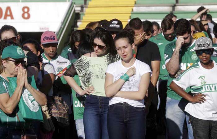 Supporters of Brazil's soccer team Chapecoense mourn the death of many of the team's players inside Arena Conda stadium in Chapeco, Brazil on Tuesday.