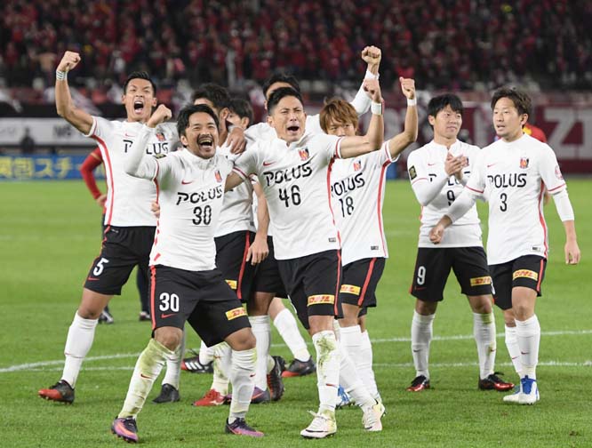 Urawa Reds players celebrate the first goal during a J-League soccer match against Kashima Antlers in Kashima, Japan Tuesday. Urawa Reds took a big step toward winning their second title with a 1-0 win away to Kashima Antlers in the first leg of the J-Lea