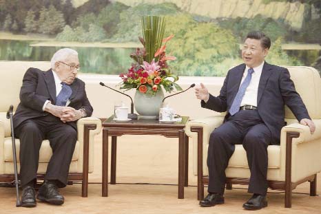 Former US Secretary of State Henry Kissinger, left, meets China's President Xi Jinping at the Great Hall of the People in Beijing on Friday.