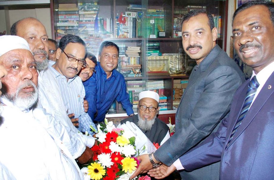 CCC Mayor AJM Nasir Uddin presenting floral bouquet to former Mayor and Chittagong City AL President Mohiuddin Chowdhury at his city residence on the occasion of 72nd birth anniversary yesterday .