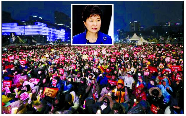 South Korean protesters hold up candles during a rally calling for South Korean President Park Geun-hye to step down in Seoul, South Korea.