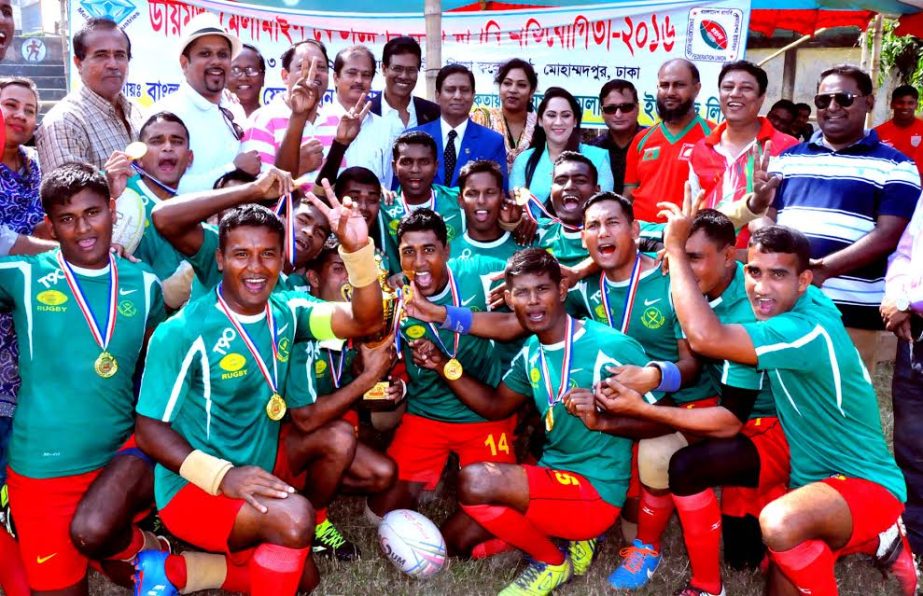 Bangladesh Army, the champions of the Diamond Melamine Federation Cup Rugby Competition with the guests and the officials of Bangladesh Rugby Federation pose for a photo session at Physical Education College Ground in Mohammadpur on Friday.