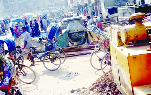 Road near Kakrail intersection turns into deplorable conditions due to slow pace of ongoing development works by DSCC causing sufferings to commuters and pedestrians. This photo was taken on Saturday.