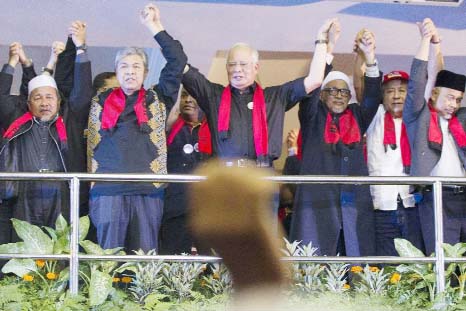 Malaysian Prime Minister Najib Razak, (centre) holds hands with other leaders during a protest against the persecution of Rohingya Muslims in Myanmar, at a stadium in Kuala Lumpur, Malaysia on Sunday.