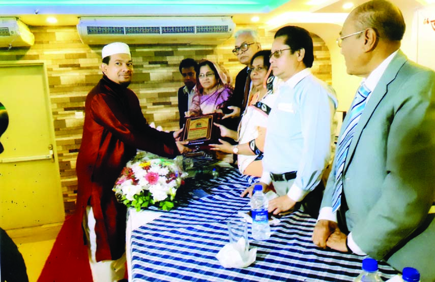 Proprietor of Ali Air Travels and Tours Hossain Ahmed Majumder receiving Human Rights Peace Award from Advocate Hosne Ara Begum Babli, MP and Advocate Hosne Ara Lutfa Dalia, MP at a ceremony organised recently to honour elite in the city's Jatiya Krira P