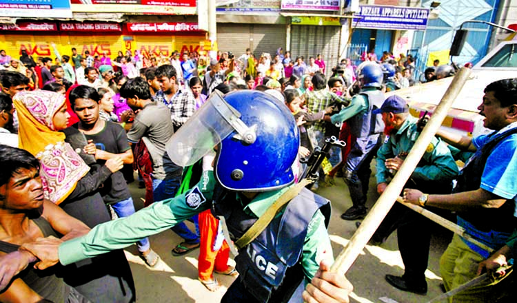 RMG factory workers blocked a road in Mirpur Section-1 demanding to payment of their dues and locked in clashes with police while they were being dispersed and baton charged on Monday.