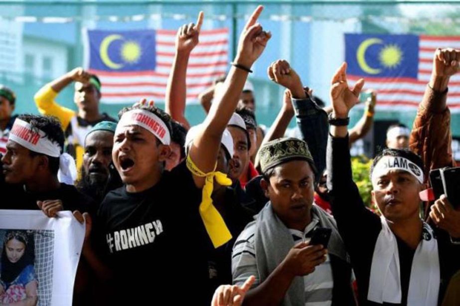 Ethnic Rohingya Muslim refugees shout slogans during a gathering in Kuala Lumpur protesting the persecution of Rohingya Muslims in Myanmar.