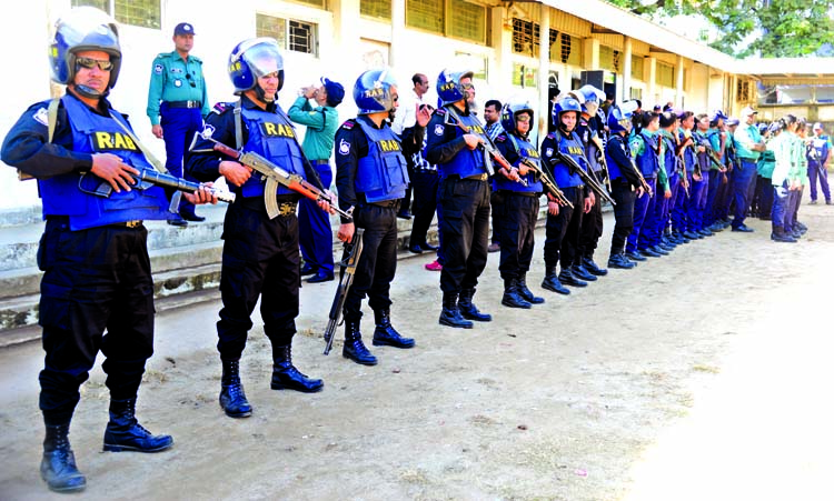 Law enforcers stand guard around the special court in the city's Bakshibazar Alia Madrasha premises on Thursday for security reasons centering Khaleda Zia's appearing before the court.