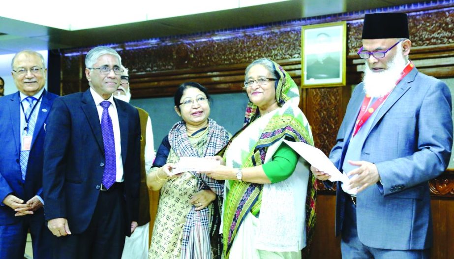 Nasim Anwar Hossain, Vice Chairperson of Prime Bank Ltd handing over a cheque to Prime Minister Sheikh Hasina at Prime Minister's Office recently. The Bank made the donation to the Prime Minister's Relief and Welfare Fund to support the poor and cold-hi