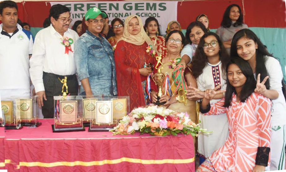 The winners of the sports competition of the picnic of Green Gems International School with the Principal GM Nizamuddin pose for a photo session at BKSP in Savar on Friday.