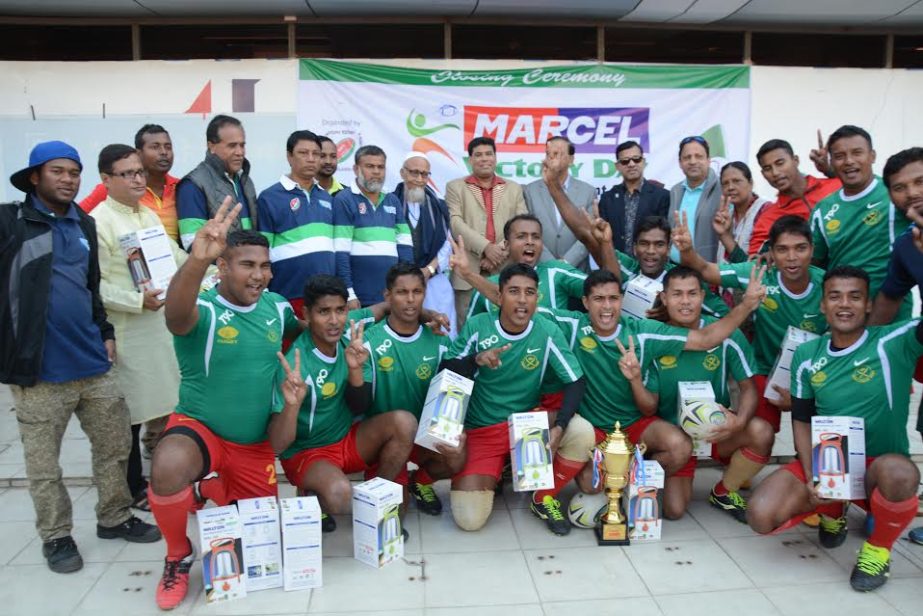 Bangladesh Army team, who became champion of the Marcel Victory Day Rugby Competition pose for photo with trophy and guests at Bangabandhu National Stadium on Monday.