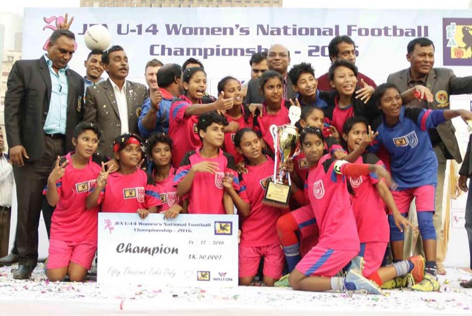 Members of Mymensingh district team, the champions of the JFA Under-14 National Women's Championship and the officials of Bangladesh Football Federation pose for a photo session at the Bangabandhu National Stadium on Wednesday.