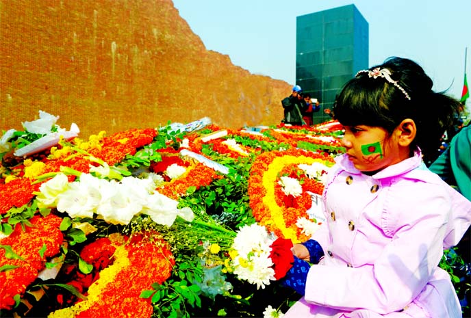 A child paying homage by placing wreath where Martyred Intellectualsâ€™ Memorial in Mirpur bedecked with flowers on Wednesday.