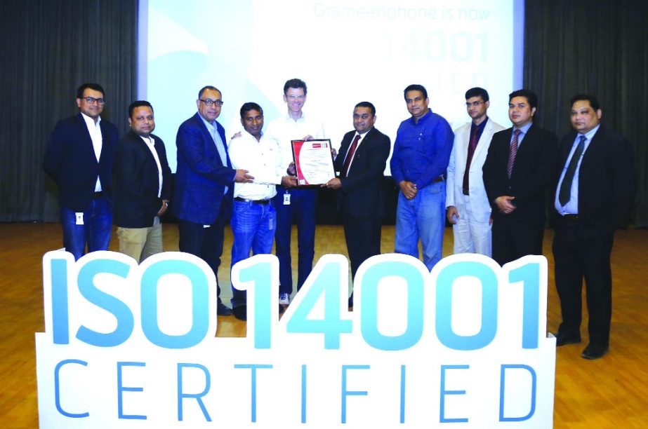 Petter B Furberg, CEO of Grameenphone (GP) receiving the ISO 14001:2004 certification for adopting Environment Management System (EMS) from Ramesh Koregave, Director of Certification of Bureau Veritas at GP House in the city recently. Medhat EL Husseiny,