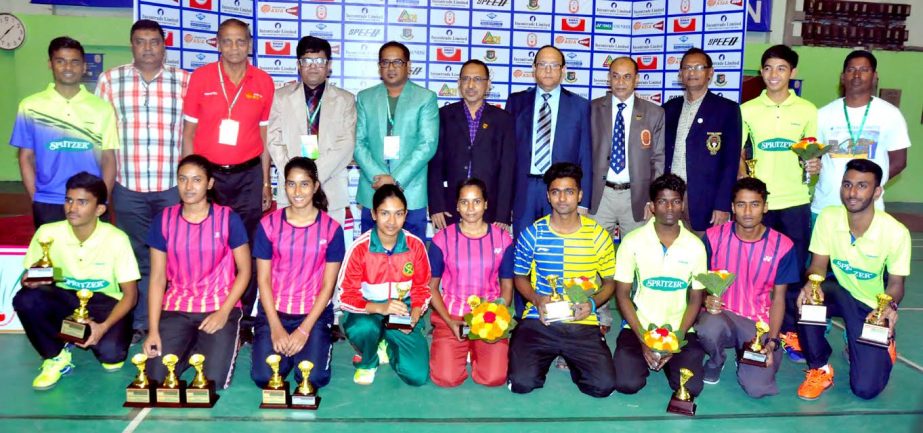 Prize winners of Bangladesh International Junior Badminton Tournament pose for photo with their trophies and guests at Shaheed Tajuddin Ahmed Indoor Stadium in the city on Thursday.