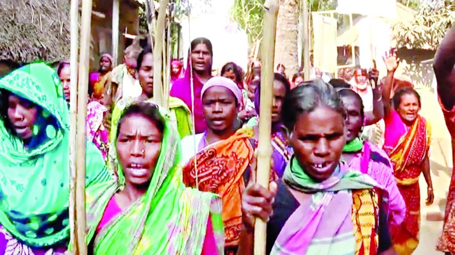 Victim female Santals staged demonstration with arrows, bows, bamboo sticks and banners demanding immediate return of their lands and protesting the cases filed against them for vandalising Rangpur Sugar Millsâ€™ boundary pillars in Gobindaganj upazi