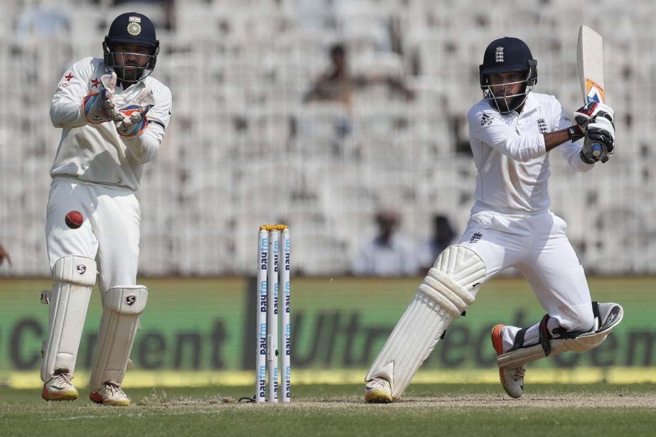 England's Adil Rashid plays a shot as India's Parthiv Patel watches during their second day of the fifth cricket test match in Chennai, India on Saturday.