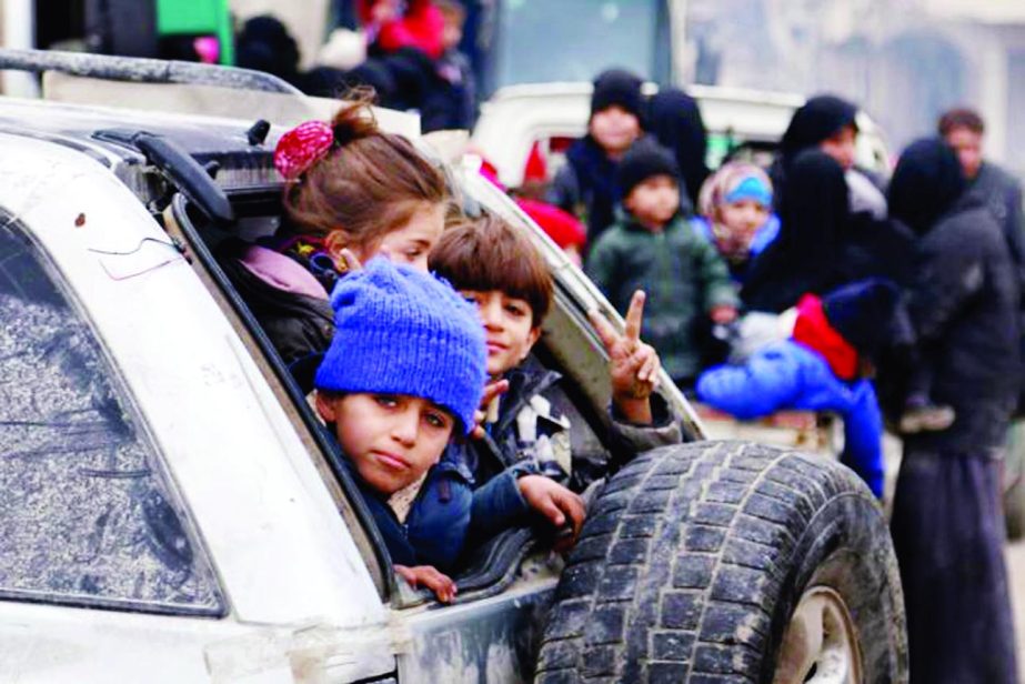 Children sit in a car as they wait to be evacuated from a rebel-held sector of eastern Aleppo, Syria.