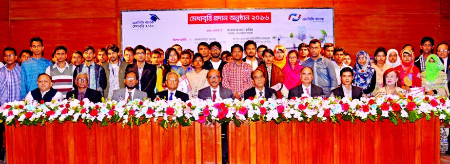 Bangladesh Bank Governor Fazle Kabir poses with the scholarship recipients of NCC Bank Ltd at IDEB auditorium in the city on Saturday. Engineer Abdus Salam, Chairman, ASM Mainuddin Monem, Vice Chairman and Golam Hafiz Ahmed, Managing Director of NCC bank