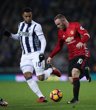 Manchester United's Wayne Rooney (right) and West Bromwich Albion's Matt Phillips battle for the ball, during the English Premier League soccer match between West Bromwich Albion and Manchester United, at the Hawthorns in West Bromwich, England on Satur