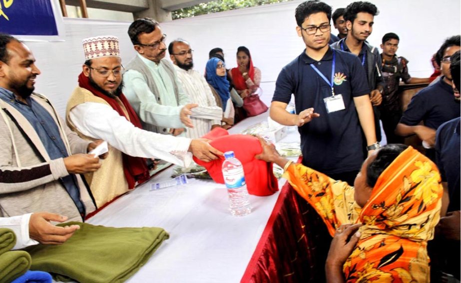 NGO Usha distributing winter clothes among the distressed people in Chittagong city recently.