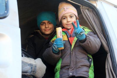 Syrian children evacuated from Aleppo arrive in opposition-controlled Khan al-Assal on Monday.