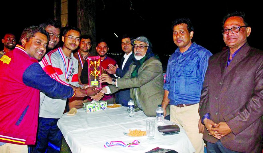 Vice-Chancellor of Bangladesh Agricultural University (BAU) of Mymensingh Prof Dr Ali Akbar handing over the championship trophy of "Bojoy Dibosh Badminton Tournament-2016"" to ""Bijoyer Shitolokkha"" team comprising with Amit Malakar of Samoy Protidin a"