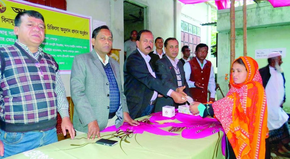 SREEBARDI (Sherpur): Cash being distributed among the poor people for treatment in Sreebardi Upazila organised by Asha, NGO on Tuesday.