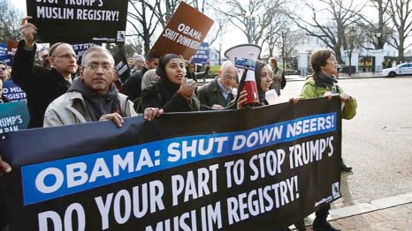 Members of Join MoveOn and DRUM march past the White House during a protest to shut down the existing Muslim registry programme NSEERS in Washington.