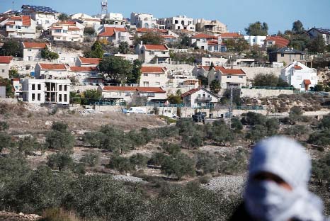 A Palestinian protestor in front of the Israeli settlement of Qadumim (Kedumim), near Nablus, in the occupied West Bank