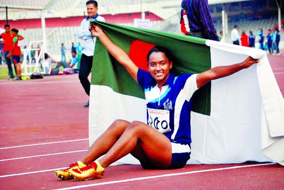 Shirin Akter of Bangladesh Navy celebrates after becoming the fastest woman in the Joyjatra Foundation 40th National Athletics Competition at the Bangabandhu National Stadium on Friday.