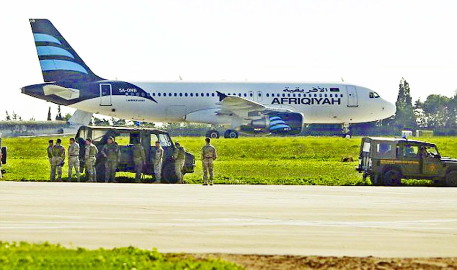 A Libyan passenger plane has been hijacked by two pro-Gaddafi supporters armed with hand grenades, it has been reported. (inset) Two hijackers were arrested after surrender to Maltese military.
