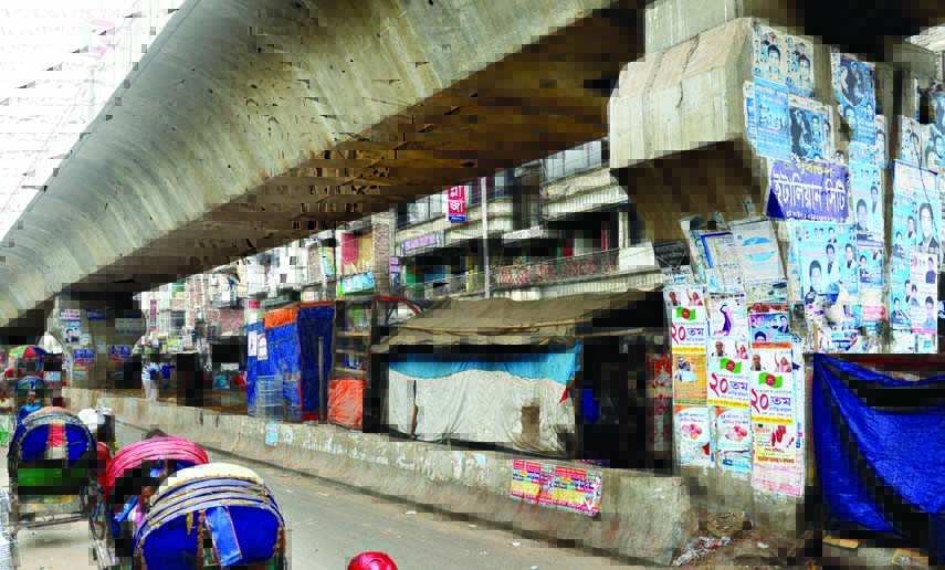 Makeshift homes built illegally in the space under the flyover causing sufferings to commuters as well as damaging the city beautification. This photo was taken from near Bangabazar area on Saturday.