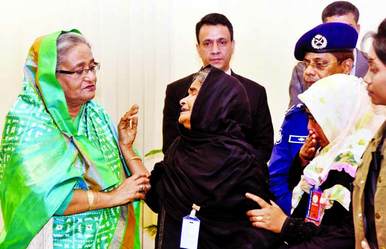 Prime Minister Sheikh Hasina giving financial donation to the family members of four policemen died in terror attacks on Holey Artisan Bakery in Gulshan and Solakia Eid Jamaat in Kishoreganj at her office yesterday.