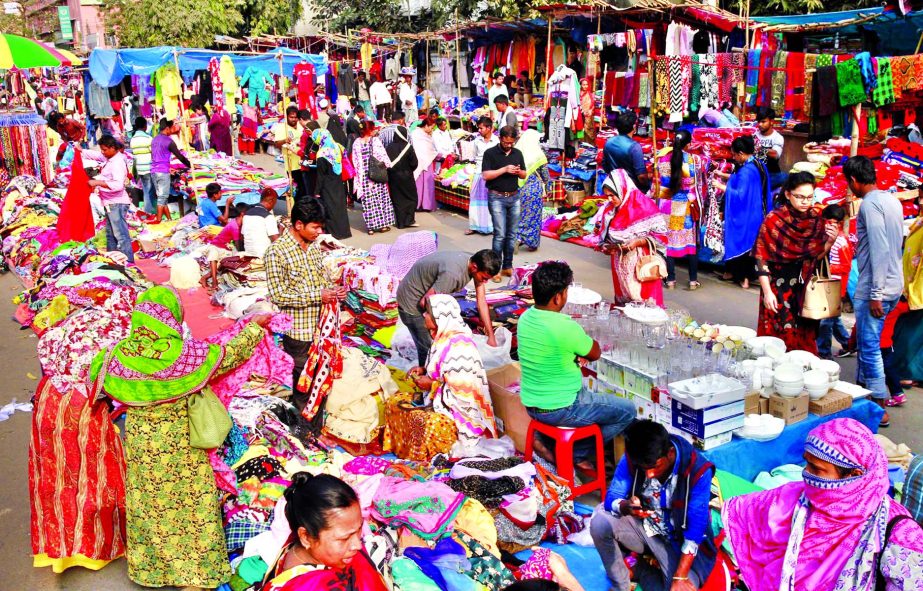 Dhaka South City Corporation has again introduced 'holiday markets' at five city spots on the weekly holidays. This picture was taken from in front of Motijheel Ideal School on Friday.