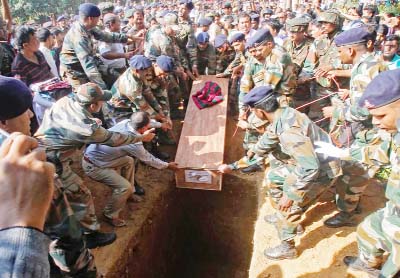 Army personnel place the coffin of Chittaranjan Debbarma, an army soldier who was killed in a militant attack on an army base near the Indian city of Jammu on Tuesday