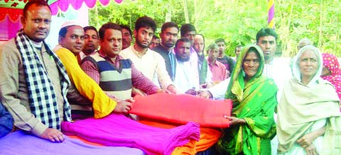 BOGRA: Dakkhinpara Adarsha Samaj Kallyan Trust distributing warm clothes among the cold -hit people in Gabtoli Upazila on Friday.