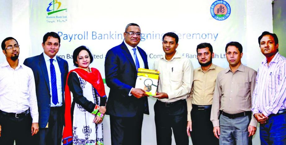 Md Khorshed Anowar, Head of Direct Business of Eastern Bank Ltd (EBL) and Md Monzur Morshed, Executive Engineer, Power Grid Company of Bangladesh exchanging documents after signing a Payroll Banking Agreement in the city recently. High officials of both o