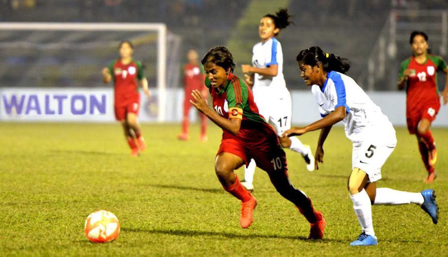 Sabina Khatun (left) of Bangladesh National Women's Football team advances with the ball during the match of the SAFF Women's Championship between Bangladesh National Women's team and India National Women's Football team at Siliguri in India on Saturd