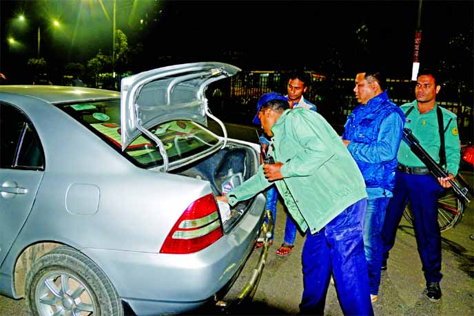 A private car being checked by the law enforcers thoroughly amid tight security ahead of 31st night in city on Saturday evening. This photo was taken from Motijheel area.