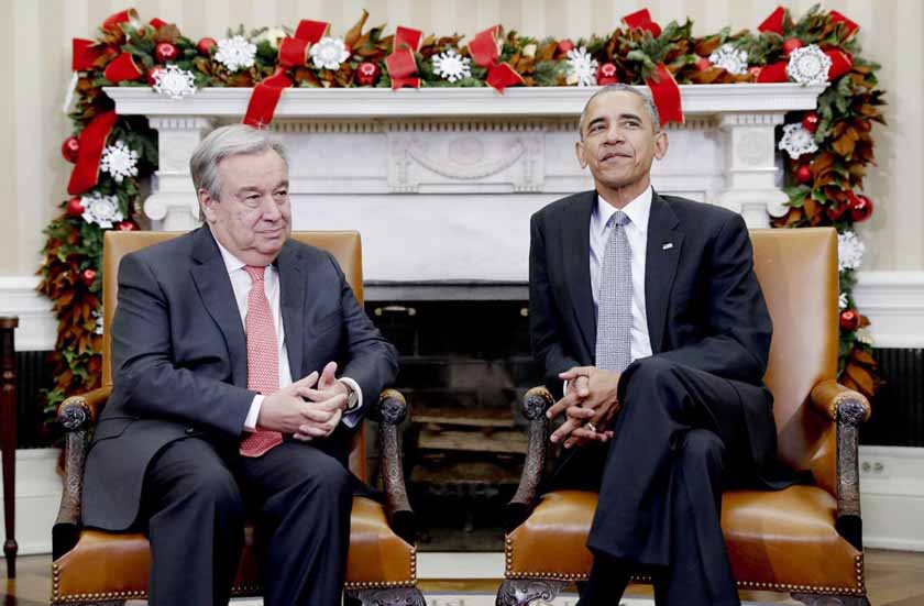 President Barack Obama pauses for media to take their places as he meets with United Nations Secretary-General-designate, Antonio Guterres, in the Oval Office of the White House in Washington.