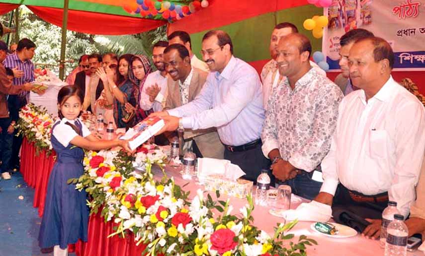 CCC Mayor A J M Nasir Uddin distributing free textbooks marking the National Textbook Festival at CCC Municipality Model School and College as Chief Guest yesterday.