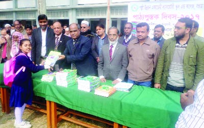 SHERPUR(Bogra): M A Matin, DG, Palli Unnayon Academy distributing textbooks among the students marking the National Textbook Festival organised by Palli Unnayon Laboratory School and College as Chief Guest on Sunday.